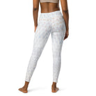 3/4 photo of a girl wearing lovely white yoga leggings (shown from the back) with a double-layered waist and the white leggings have subtle check patterns. The image is cropped and you can only see her athletic pants from her feet up to the bottom of her workout bra.