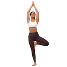 Girl in Yoga Pose Standing on one leg against a white background, wearing Salt Skins Black Color Flecks Yoga and Workout Pants. She is also wearing a white workout top.