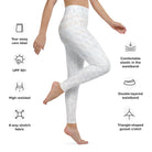 Gorgeous side view of a girl with light skin wearing Salt Skins' must have white yoga and exercise leggings. The image is cropped from the waist to the floor and she is barefoot.  You can see the subtle, barely noticeable patterns in the performance fabric. Icons surround the image, showing a high-waisted, four-way stretch, comfortable waistband, and a triangle-shaped gusset crotch.